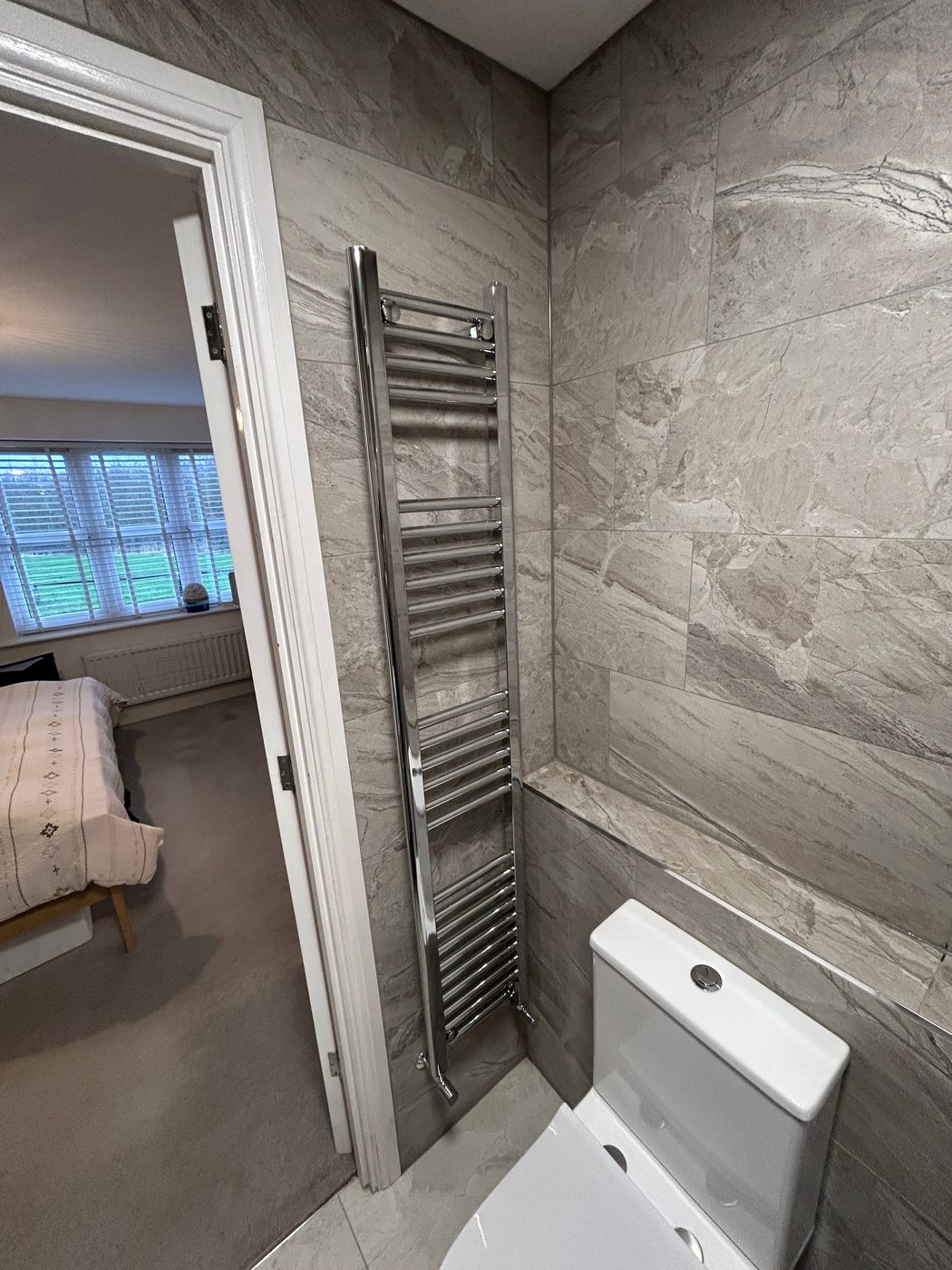 Chrome towel radiator fitted in a refurbished bathroom by K3 Gas Group